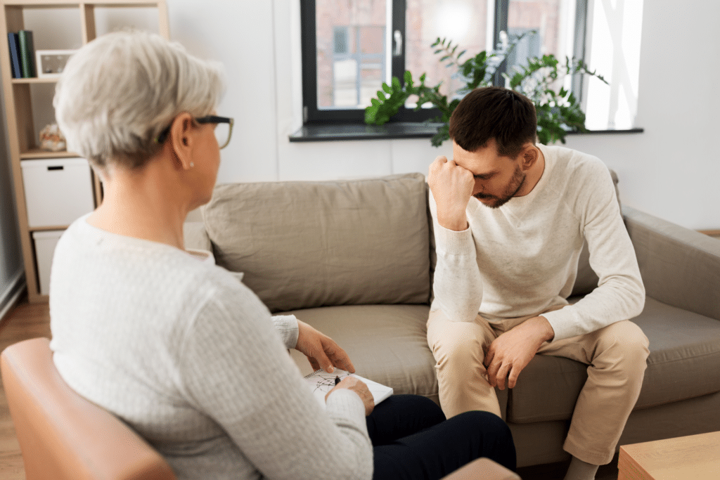 A man looking depressed, on a therapist's couch